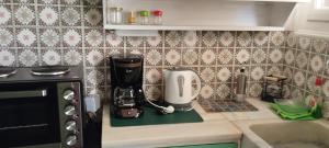 a kitchen counter with a coffee maker on a counter top at Alexandra's house in Arta