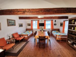 a living room with a table and a couch at Chaloupka Svratouch in Svratouch