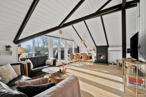 a living room with couches and a fireplace at 30371-Ulfborg-Valmuevej-281 in Vang