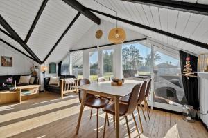 a dining room with a table and chairs at 30371-Ulfborg-Valmuevej-281 in Vang