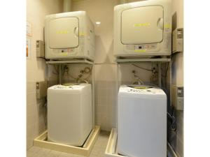 a bathroom with two machines in a room at Smile Hotel Sakurambo Higashine - Vacation STAY 92782v in Higashine +7 photos