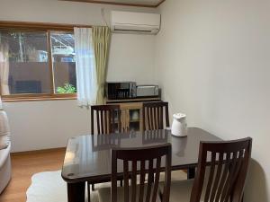 a dining room with a table and chairs and a microwave at Hanano wa - Vacation STAY 96015v in Nikko