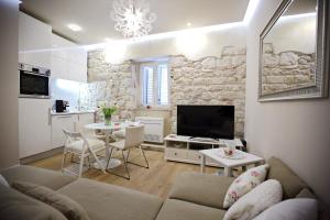 a living room with a couch and a table at Apartment White Stone - Diocletian Palace in Split