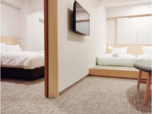 a hotel room with two beds and a mirror at DIG the Osaka - Vacation STAY 14520v in Suita