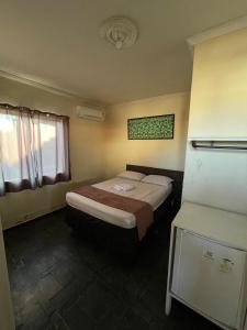 a hotel room with two beds and a window at Pousada Dom Rey in Cabo Frio +18 photos
