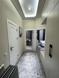 a hallway with two doors and a room with a table at Anisa guest house in Samarkand