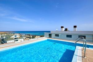 a swimming pool with a view of the ocean at Sal & Mar in Santa Maria