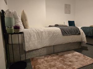 a bedroom with a large bed with a rug at Room 2 shared house 5 minutes from Anfield in Liverpool