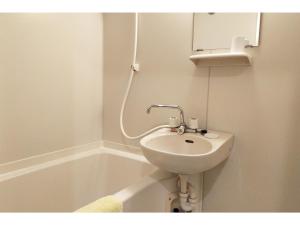 a white bathroom with a sink and a bath tub at Hotel Pacific - Vacation STAY 07373v in Ishinomaki