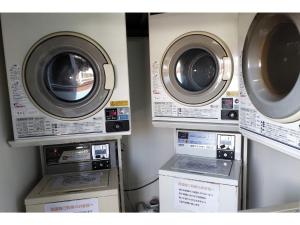 two washing machines and a washer and dryer in a room at Hotel Pacific - Vacation STAY 07296v in Ishinomaki