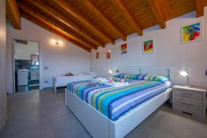 a bedroom with a large bed and two tables at Villa Laura Private Pool and Garden - Happy Rentals in Besozzo