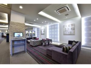 a living room with a couch and a fireplace at K,M,H Art hotel by Kure Morisawa - Vacation STAY 23294v in Kure