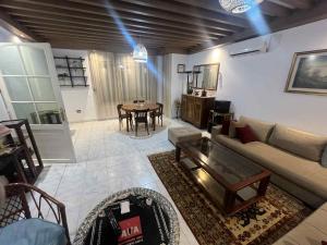 a living room with a couch and a table at Villa Bel air in Aïn Draham