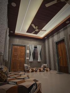 a room with two beds and a ceiling fan at Sea view villa in Kondivli