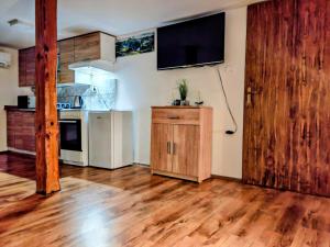 a kitchen with wooden floors and a large wooden door at Gostilna The RIVER in Dravograd