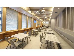 金沢市にあるSmile Hotel Kanazawa Nishiguchi Ekimae - Vacation STAY 24204vのテーブルと椅子と窓のあるダイニングルーム
