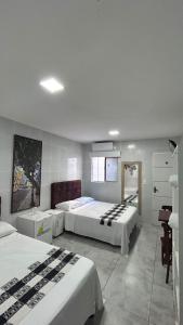 a hotel room with two beds in a room at Pousada Praia Boa Viagem in Recife
