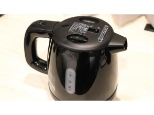 a black coffee pot is sitting on a table at Smile Hotel Kanazawa Nishiguchi Ekimae - Vacation STAY 11502v in Kanazawa