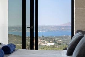 a bedroom with a view of a body of water at Villa Grand Fysaeri in Vamos