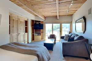 a bedroom with a bed and a couch and a table at Timberline Condominiums Studio Deluxe Unit 217 in Snowmass Village