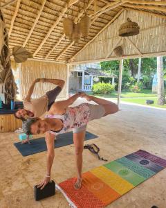 a woman and man doing yoga in a room at Beach Bungalow 100 m Playa Coson in Las Terrenas +55 photos