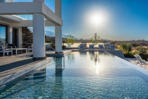 a swimming pool in a villa with a view at Villa Grand Fysaeri in Vamos