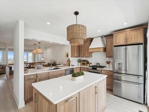 a kitchen with wooden cabinets and a white counter top at Oceanview Townhome by Leavetown Vacations in Bethany Beach