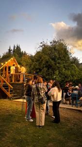 a group of people standing outside of a playground at Alaska Patagonia Hostel in San Carlos de Bariloche +53 photos