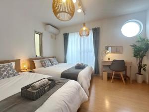 a bedroom with two beds and a desk and a chair at NAGOMI - Vacation STAY 16320v in Yamatokoriyama
