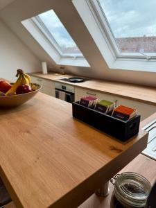 a kitchen with a bowl of fruit on a table at Lupi Blue - stylish und cosy Apartment in Buchen