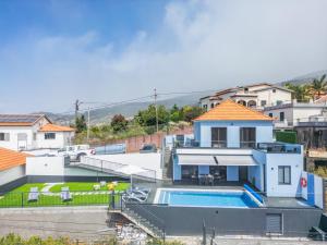 a villa with a swimming pool and a house at Orinoco Sunset House I - Private Jacuzzi in Calheta