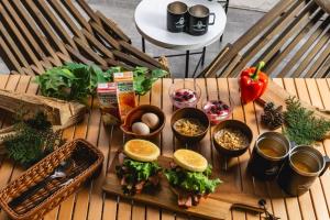 a wooden table with sandwiches and other food on it at TOCORO. Mt.Fuji CAMP & GLAMPING - Vacation STAY 23389v in Oishi