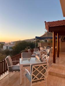 a group of tables and chairs on a patio at Eighth Wonders Hotel in Wadi Musa