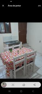 a table with a bed in a room at Casa Bela Vista in Blumenau