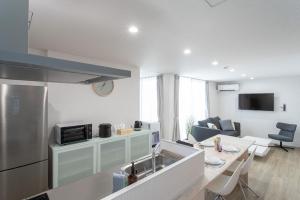 a kitchen and living room with a sink and a stove at CAN LI ASSO - Vacation STAY 25225v in Minami Aso
