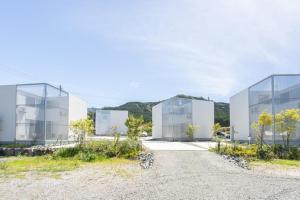 a group of glass buildings on a gravel road at CAN LI ASSO - Vacation STAY 25225v in Minami Aso