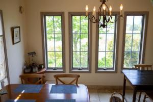 a dining room with a table and four windows at Kanon suisha - Vacation STAY 26689v in Kawaba +6 photos