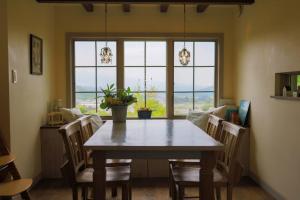 a dining room with a table and chairs and windows at Kanon suisha - Vacation STAY 26604v in Kawaba