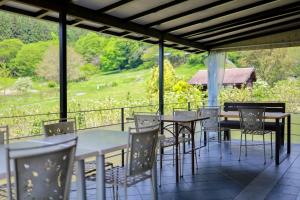a row of tables and chairs on a patio at Kanon suisha - Vacation STAY 25508v in Kawaba +5 photos