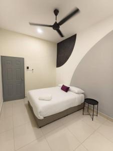 a bedroom with a bed with a ceiling fan at Hello Pangkor Home 73A - A Nest for 12 buddies in Pangkor