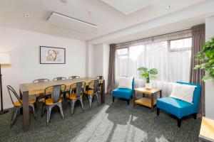 an office with a conference room with a table and chairs at Hotel Give in Christchurch +112 photos