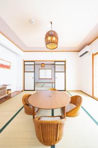 a living room with a table and chairs at Soyo in Tsumagoi