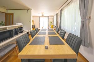 a conference room with a long wooden table and chairs at Soyo in Tsumagoi +56 photos