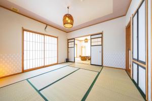 an empty room with a door and windows at Soyo in Tsumagoi
