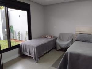 a bedroom with two beds and a window at StudioD in Passo Fundo
