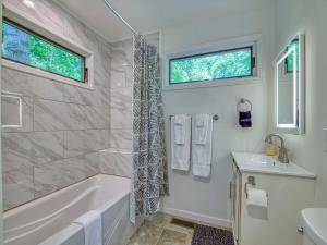 a bathroom with a tub and a sink at Windows Over Waterfalls in Hot Springs +43 photos