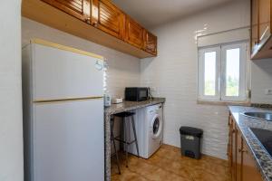a kitchen with a refrigerator and a washing machine at Olivais 2br - Metro & Airport By Perfect Getaway in Lisbon