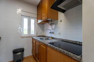 a small kitchen with a sink and a window at Olivais 2br - Metro & Airport By Perfect Getaway in Lisbon