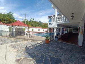 a house with a swimming pool and a patio at Hotel Santo Lomo in La Vega
