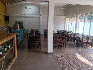 a dining room with tables and chairs and windows at Hotel Santo Lomo in La Vega +8 photos